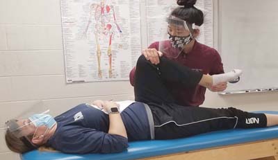 UConn Accelerated Athletic Training 4+1 Master's Program image of exercise physiologist assisting a patient.