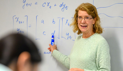 UConn Economics faculty member giving lecture in classroom